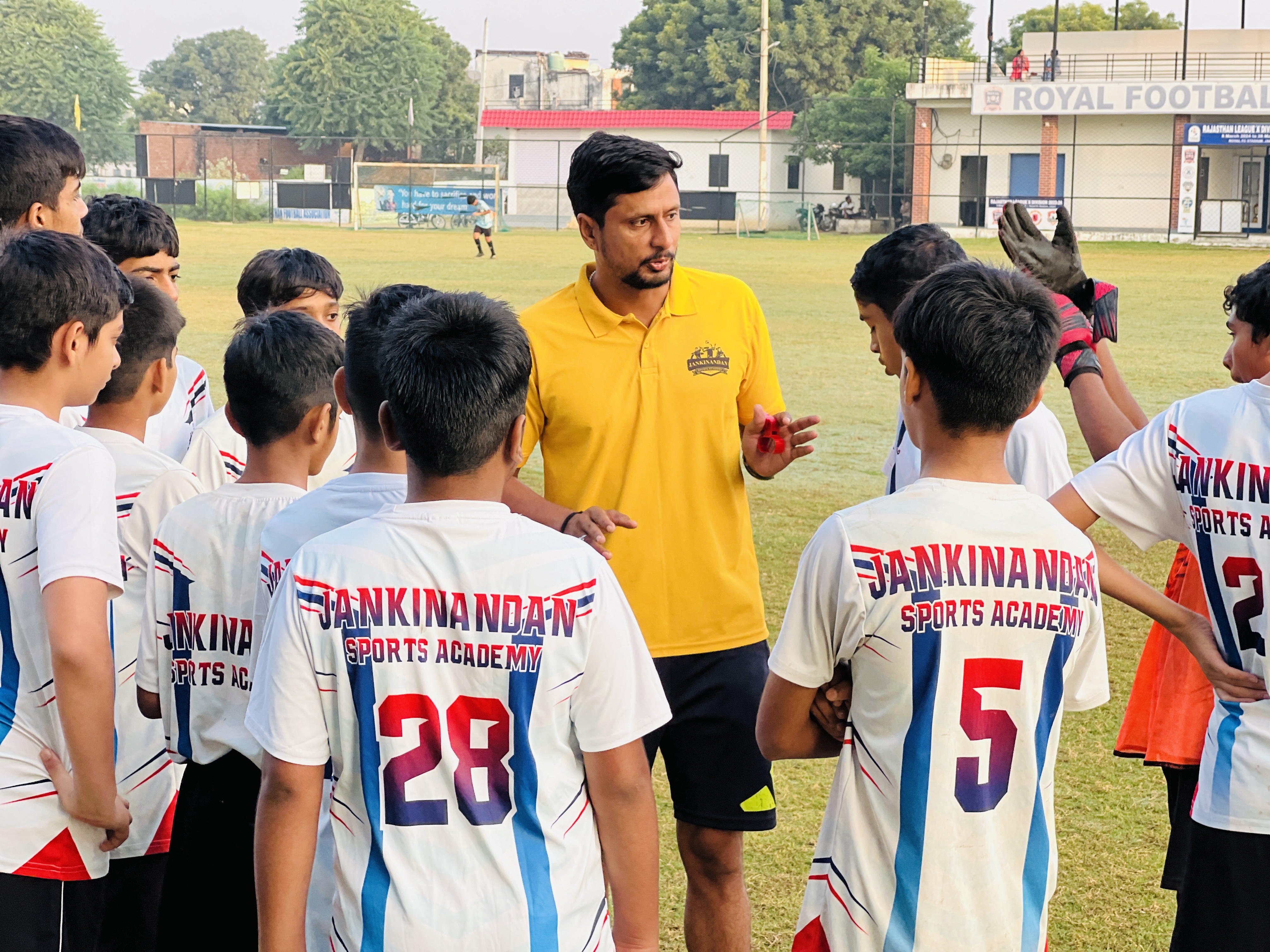 Jankinandan Sports Academy — coach instructing students on field